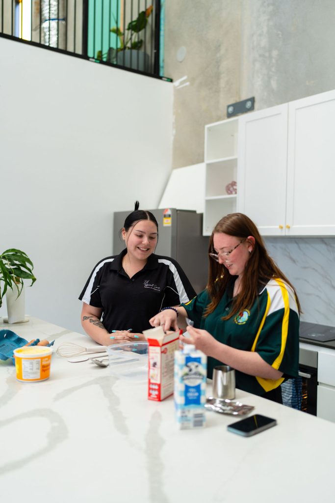 Women socialising and cooking at SpiritCare NDIS